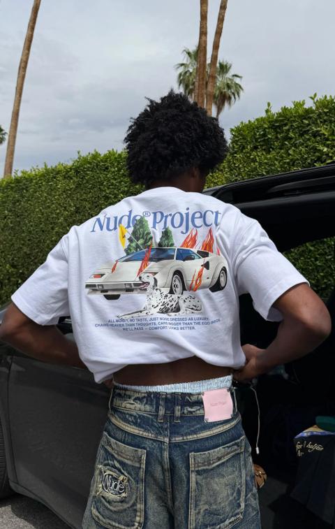 Person seen from behind in a Nude Project graphic T-shirt and denim