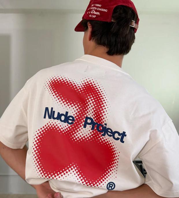 Nude Project campaign photograph — the brand's logo tee shot from behind